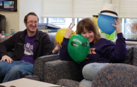 Students with baloons on a couch